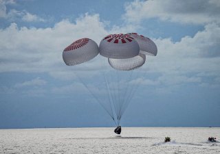 Kapsle SpaceX se spustila do oceánu těsně před západem slunce.