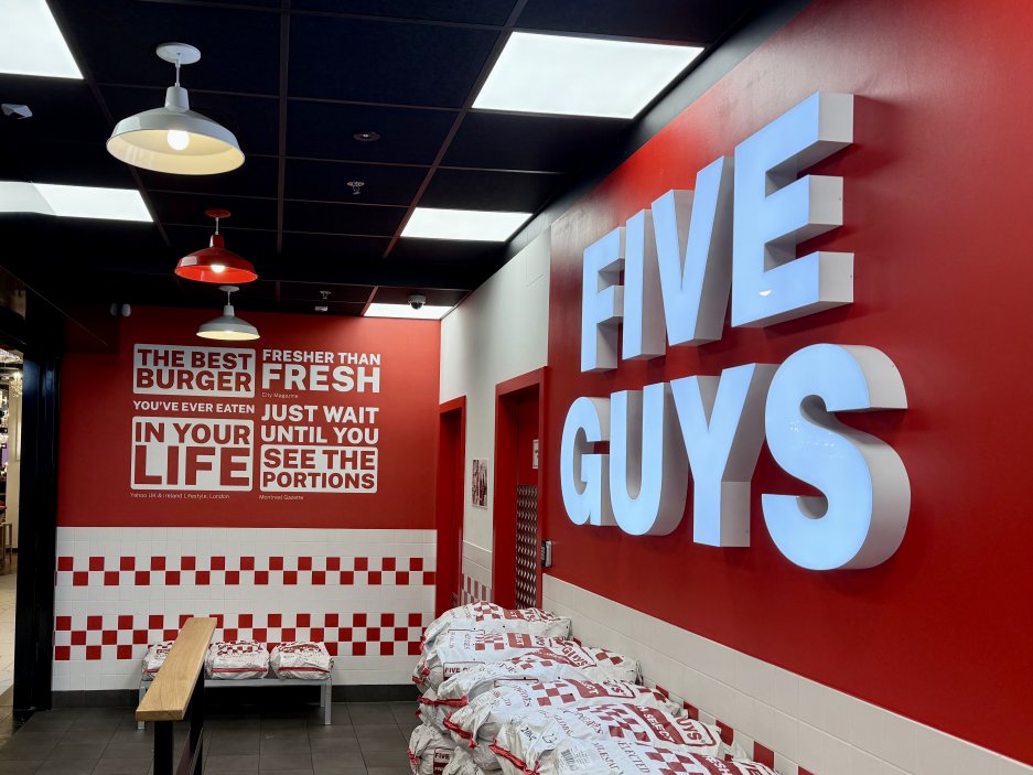 Interiér s červenobílými dlaždicemi a výrazným logem kopíruje design poboček Five Guys po celém světě