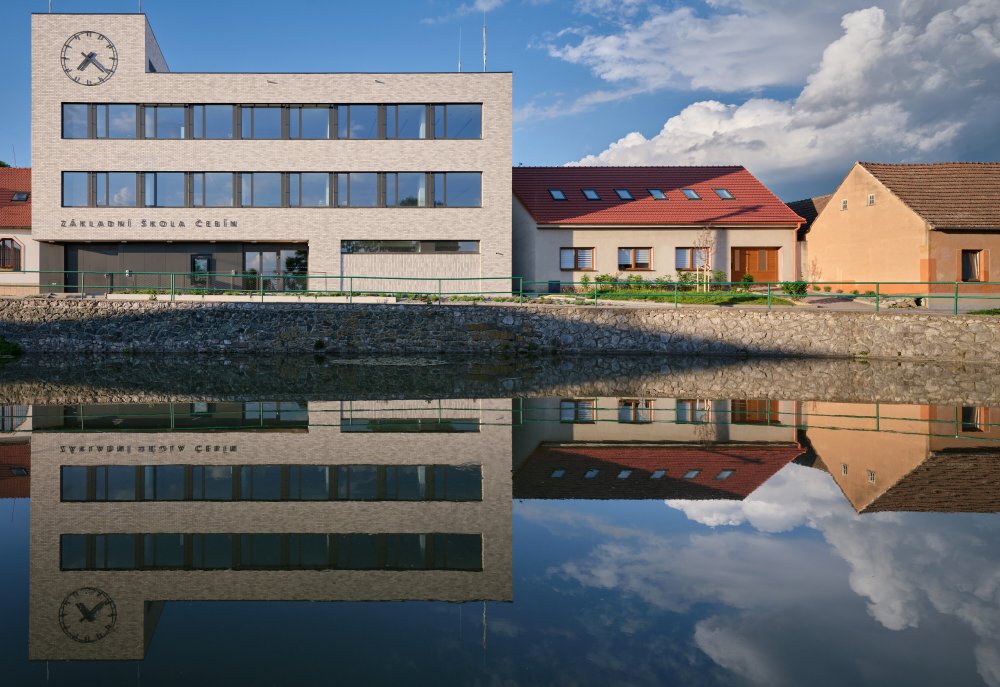 Bývalý obchodní dům Jednota ze 70. let dostal v Čebíně nový život. Brněnské studio knesl kynčl architekti jej proměnilo v moderní školu pro zhruba 120 žáků, která doplnila chybějící druhý stupeň a stala se novou součástí života na návsi. Projekt ukazuje, že i zdánlivě přežité stavby mohou místo demolice získat smysluplnou současnou funkci.